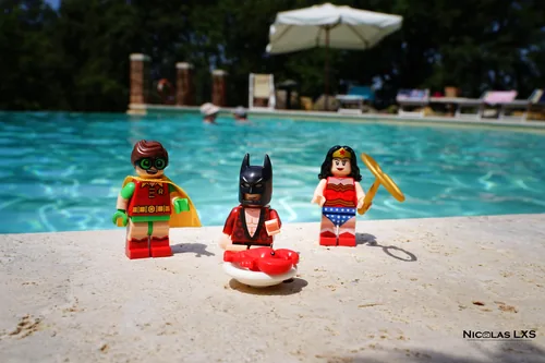 Figurines LEGO de Robin, Batman et Wonder Woman au bord d'une piscine